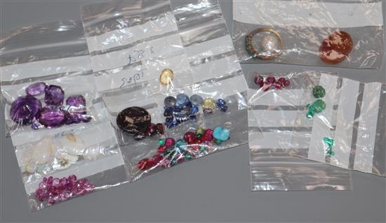 A collection of assorted unmounted gem stones, including white opal, amethyst, turquoise and citrine.